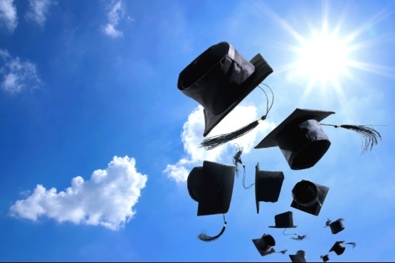 Graduation caps to sky